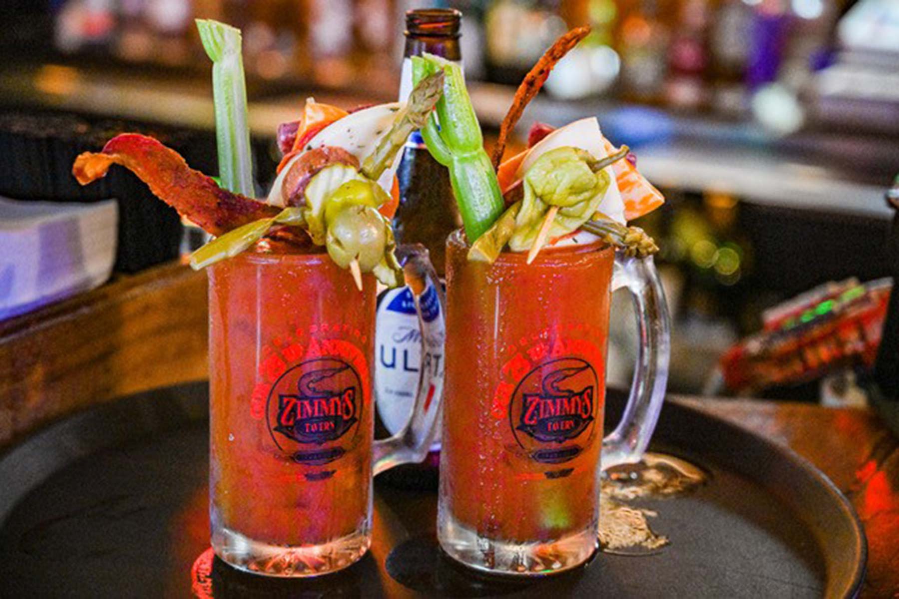Two Bloody Mary's stacked high with delicious garnishes